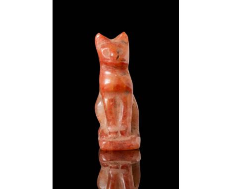 Late Period, Ca. 664 - 332 BC. A carnelian cat amulet, finely carved in a seated position with an upright posture. The head f