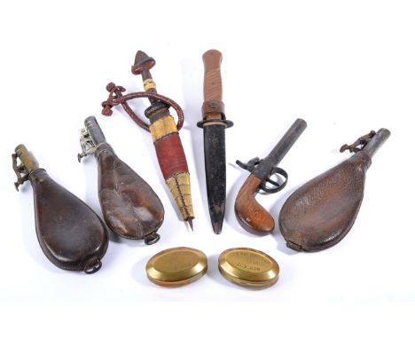 A Trench Knife, with hatched wood grip, enamelled metal scabbard; a Sudanese arm dagger; three leather shot flasks; a contine