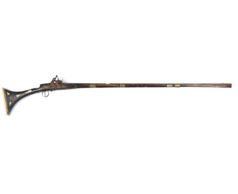 A 19th Century North African Snaphance Longarm, the steel barrel, length 120 cm, with engraved decoration, the lock, cock and