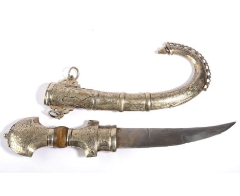 An Arab Jambiya, with 20cm curved double edge steel blade, the white metal hilt and curved scabbard engraved with scrolling f