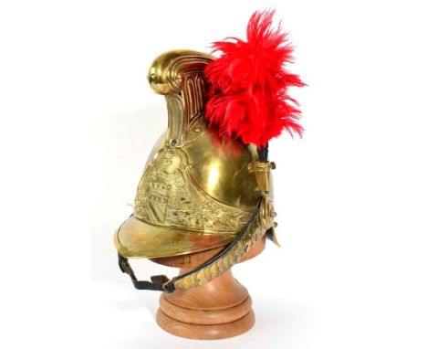 A Copy of a French Cuirassier's Brass Helmet, with raised fluted comb, a crimson plume set to the left side of the skull, the