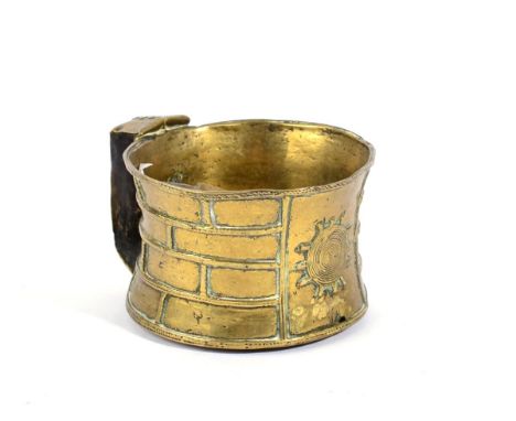 An African Ashanti Brass Cup, of waisted circular section, relief with a brickwork trellis pattern and sunburst design, angul