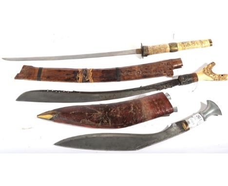 A Nepalese Gurkha Kukri, the 37cm unmarked steel blade with two narrow fullers to the back edge, the aluminium hilt with bras