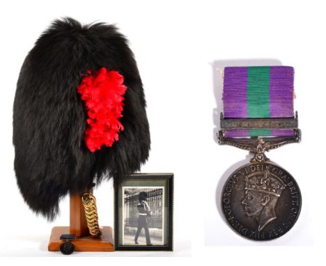 A Coldstream Guards Other Ranks Bearskin Cap, with wicker cage frame, leather liner, maker's label dated 1981, with black vel
