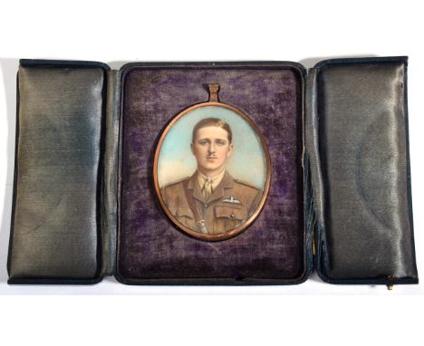 A Miniature Portrait of an RFC Officer, in No.2 dress uniform, half length, painted over photograph, in a gilt metal pendant 