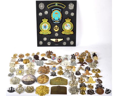 A Royal Artillery Plated Busby Badge and Plume Holder; twenty-six various British cap and uniform badges, helmet plates, rank