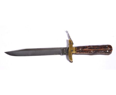A Folding Bowie Knife, the clip point blade stamped, ''M. I. Ltd.''  to the ricasso, brass crossguard with folding, locking l