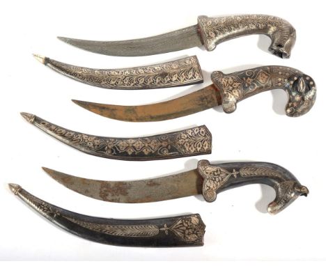 Three Indian Small Daggers, each with faux damascined curved steel blade, the hilt modelled as an animal, with scabbard, all 