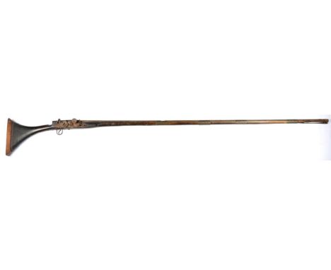 A 19th Century North African Snaphance Longarm, the steel barrel, length 161.5 cm with four ornamented brass bands and cast i