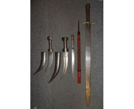 A SUDANESE SWORD (KASKARA); TWO PERSIAN DAGGERS (JAMBIYA); A SHORT YATAGHAN DAGGER AND A JAPANESE SPEAR (NAGINATA) the first 