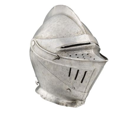 A SOUTH GERMAN CLOSE HELMET FOR HEAVY FIELD USE, NUREMBERG, CIRCA 1550 with rounded one-piece skull rising to a high file-rop