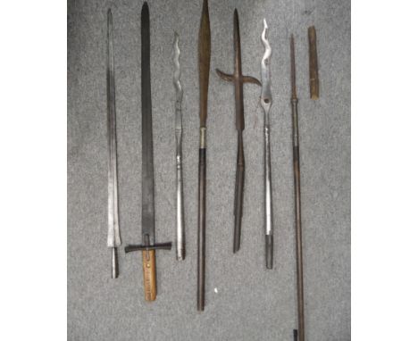 TWO CHINESE HAFTED WEAPONS; TWO SOUTH EAST ASIAN SPEARS; A SUDANESE KASKARA, AND TWO FURTHER HAFTED WEAPONS the first and sec