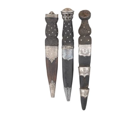 THREE SCOTTISH DAGGERS (SKIAN DHU), 20TH CENTURY each with tapering blade formed with a scalloped back-edge, the first etched