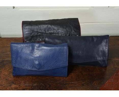 A GROUP OF THREE OF MULBERRY'S FIRST LEATHER CLUTCH BAGS  DESIGNED BY ROGER SAUL, ALL MADE IN THE MID 70'S NAVY BLUE LEATHER 
