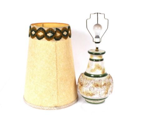 A large 1970's continental pottery baluster table lamp, cream and green glaze with raised stylised decoration, wool work embr