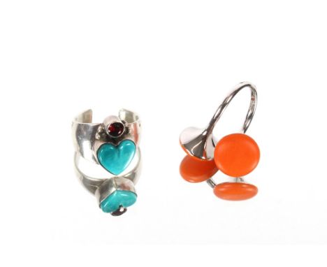 A Sterling silver G.A.C. ring with an enamel heart and single red stone; and a modernist silver cross over ring with orange e