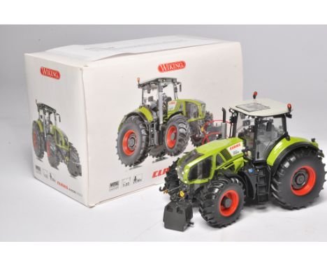 Farm Model Issue comprising 1/32 Wiking Claas Axion 950 in original box and packaging. Model has been fitted with working lig