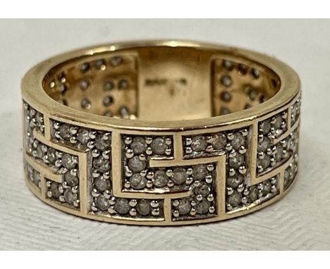 A 9ct eternity ring set with single point diamonds in Greek key pattern 6g gross, size R.