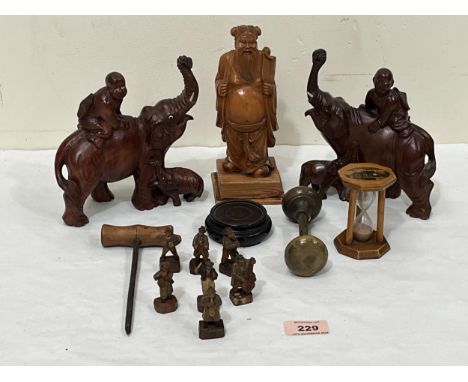 A box of carved treen and metalware to include a figure of a sage, Maucheline ware egg timer, a septet of carved musicians et