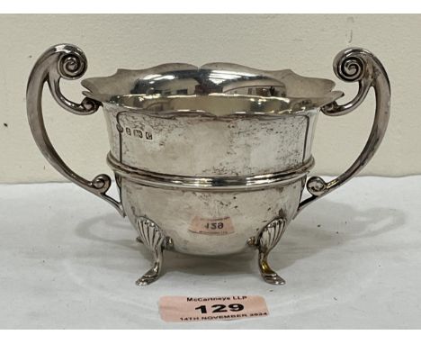 A George V silver sucrier with scroll handles on shell moulded feet. Birmingham 1927. 5½" diam over handles. 4ozs 14dwts