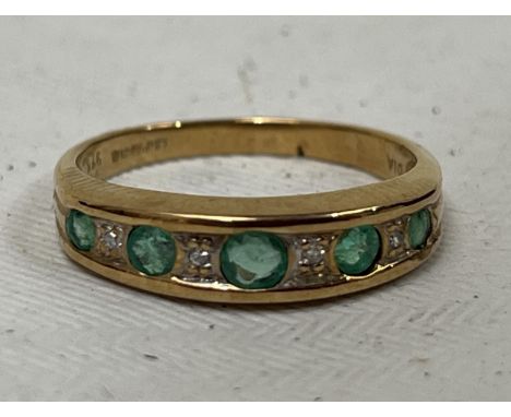 A 9ct emerald and diamond ring. 2g, size N.