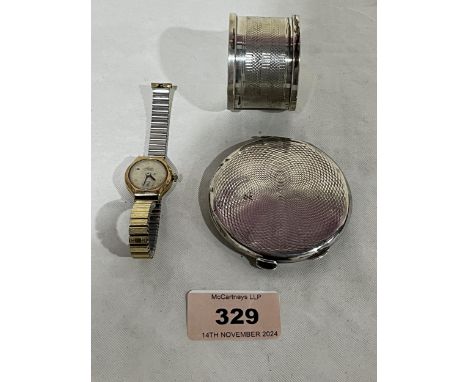 A silver powder compact (AF); a silver napkin ring and a 9ct cased lady's wristwatch.