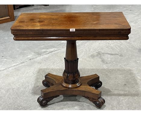 An early Victorian rosewood card table with inlet fold-over top, on lappet moulded column and quadripartite base with volute 