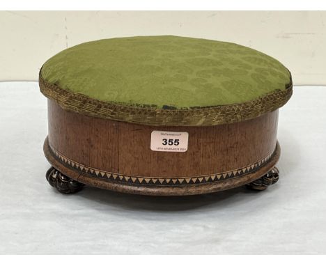 A Victorian walnut and inlaid work box / footstool with hinged lid on ceramic feet. 12" diam.