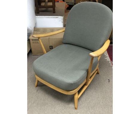 An Ercol Blonde wooden armchair, model 203. 84cm tall.