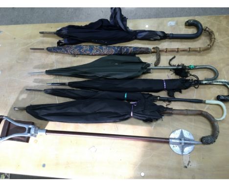A collection of vintage umbrellas and a seat stick. Postage D. NO RESERVE