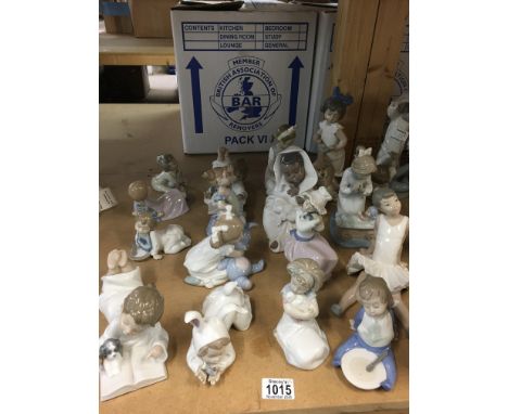 A collection of Nao child figures including ballet girl, child with puppy and book, child with rabbit teddy etc