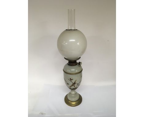 A Victorian opaque glass and enamel decorated oil lamp with an opaque shade and glass chimney, Victorian spelter oil lamp an 