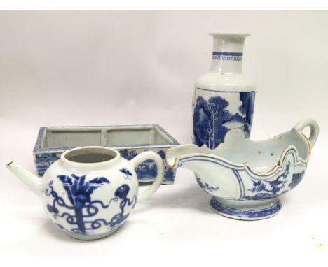 A collection of Chinese blue and white ceramics including a sauce jug with floral and bird design, a rouleau vase with landsc