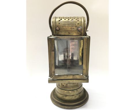 An early French brass car lamp by Albert Butin Paris. 27cm tall. This lot cannot be posted