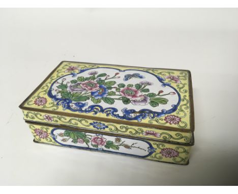 A Chinese yellow enamel box of rectangular shape with a hinged lid 16cmx10cm