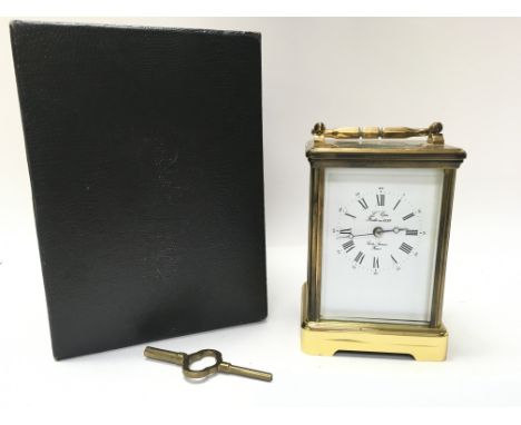 A boxed L Epee French brass carriage clock with decorated with ceramic side panels. Including key, seen working. Postage cate