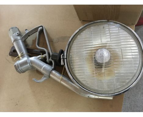 A vintage petrol pump nozzle and car spotlight