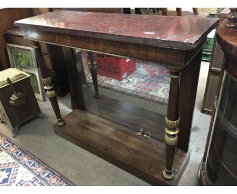 A Period Regency circa 1810 Console table with a red rectangular marble top above gilded rosewood pillars and inset with a re