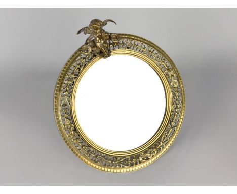 A Nice Quality Circular Pierced Brass Framed Easel Mirror with Cherub Finial, 25cms Diameter