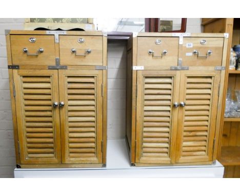 A pair of military style light oak cabinets, fitted two drawers, and louver style doors 