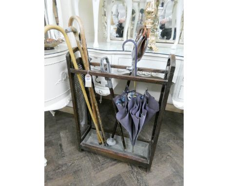 A 1920's cane panel stick stand and contents 