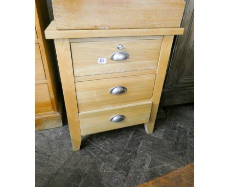 A modern light oak, three drawer, bedside chest 