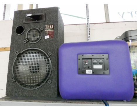 A very large acoustic studio monitor speaker and a mauve faux leather footstool speaker 