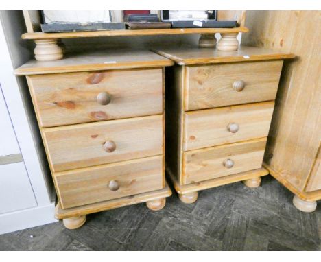 A pair of light oak finished bedside chests each fitted three drawers 