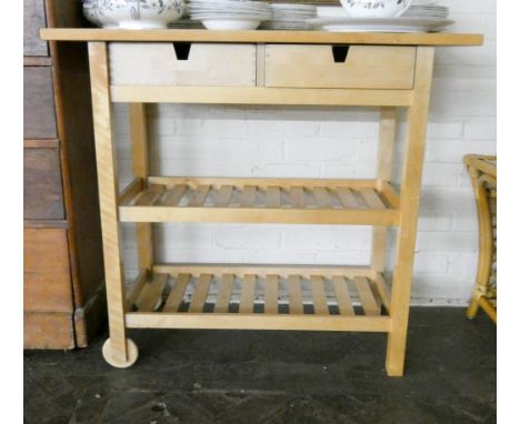 A pine three tier kitchen shelf unit fitted drawers 