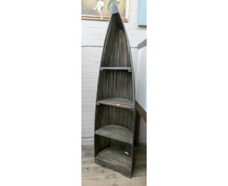 A tall boat shaped reclaimed timber bookcase or display shelf with painted decoration 