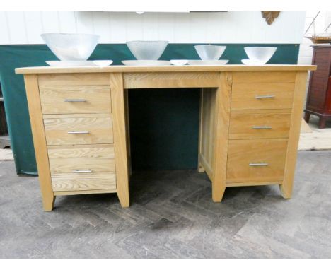 A modern light oak kneehole pedestal desk or dressing table, fitted six drawers, 58" wide 