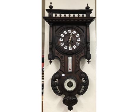 A Victorian carved walnut combination wall clock 