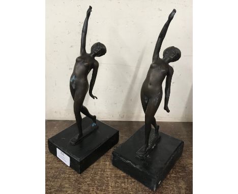 A pair of bronze figures of female nudes, on black marble socles