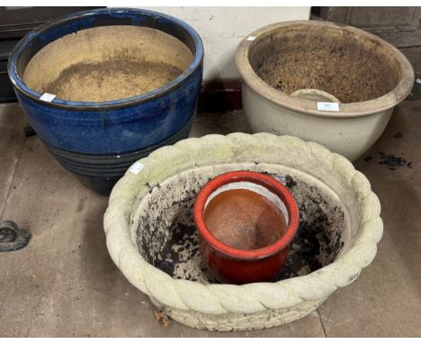 A concrete garden planter and five ceramic plant pots 